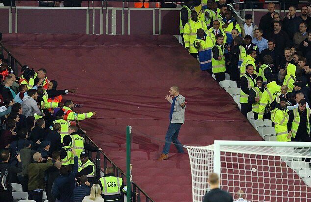 IS THIS HOW IT STARTED? A CHELSEA FAN SOMEHOW EVADES STEWARDS  AND MAKES HIS WAY TOWARDS THE IRONS SECTION BAITING THEM AS HE GOES BEFORE QUICKLY DOING AN ABOUT TURN AFTER THIS IMAGE WAS TAKEN. IDIOCY OF THE HIGHEST POSSIBLE ORDER.